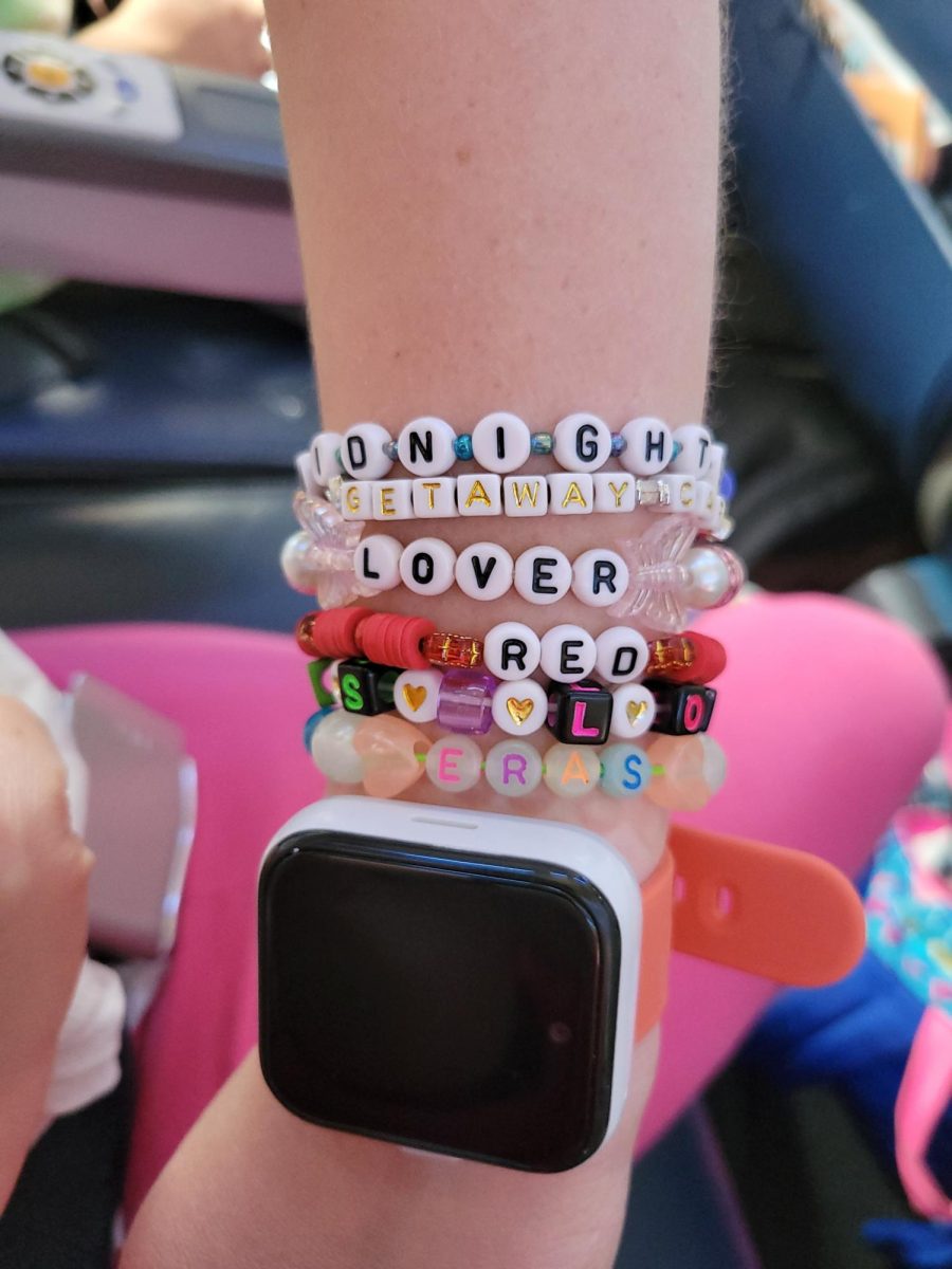 MAKE THE FRIENDSHIP BRACELETS Allen sports beaded bracelets at the concert. A trend among Swifties, creating bracelets with songs and lyrics. “the lyrics "Long live all the mountains we moved, I had the time of my life fighting dragons with you" bring back the names and faces of so many students that I have been honored to know over the years.” Allen says. PHOTO COURTESY OF KAT ALLEN
